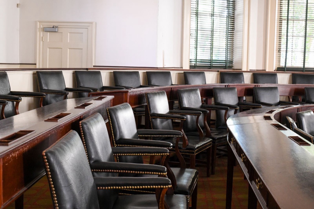 A congress hall with rows of wooden seats