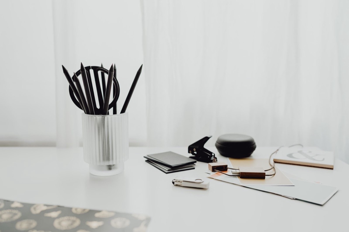 A white desk with office supplies